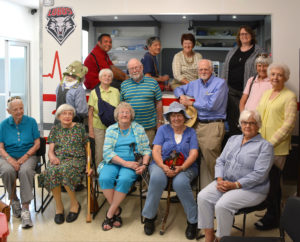 A group of people sitting in chairs posing for the camera.
